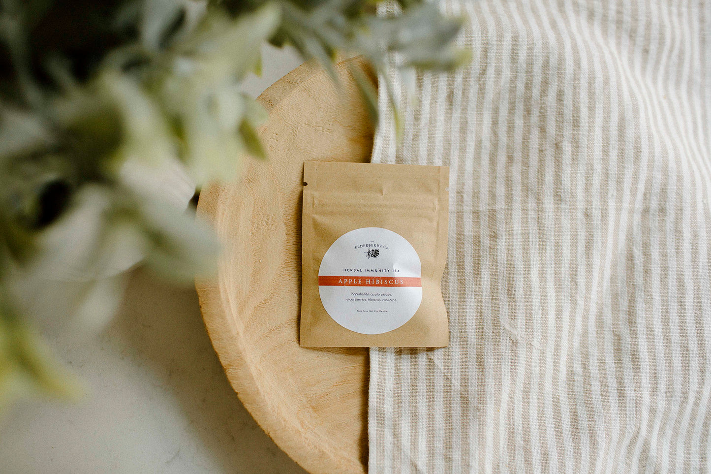 Small brown paper package with a label on a wooden surface