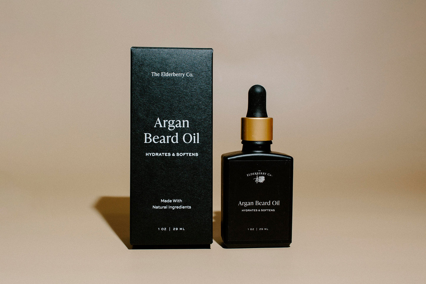 Argan beard oil bottle and packaging on a beige background