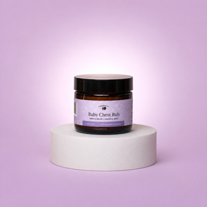Jar of 'Baby Chest Rub' on a white pedestal against a light purple background