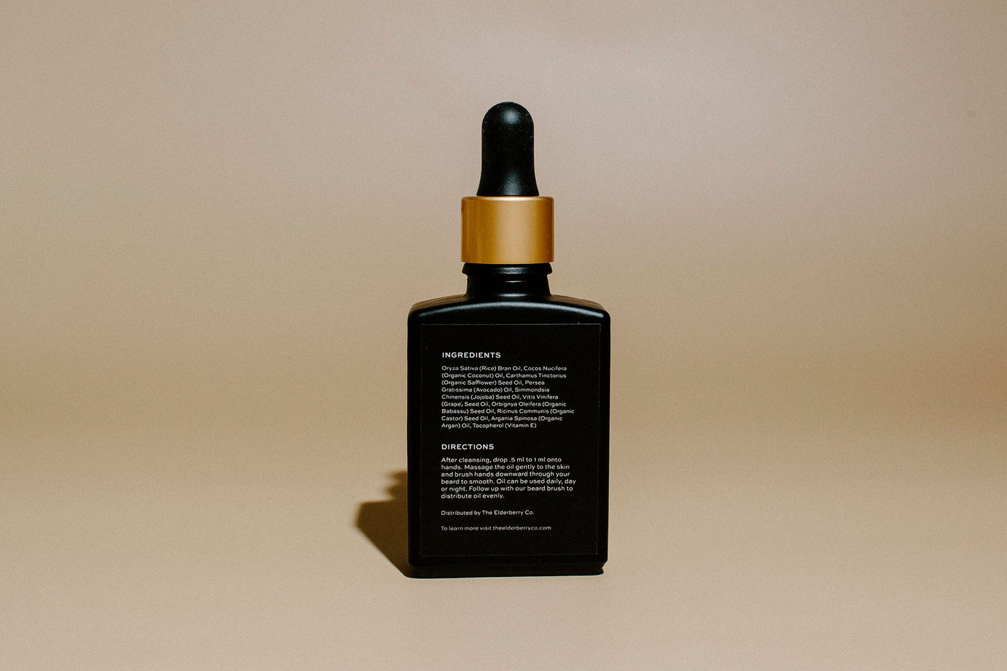 Back view of Elderberry Co. Argan Beard Oil bottle showing ingredients and directions for use on a premium beard conditioning oil.