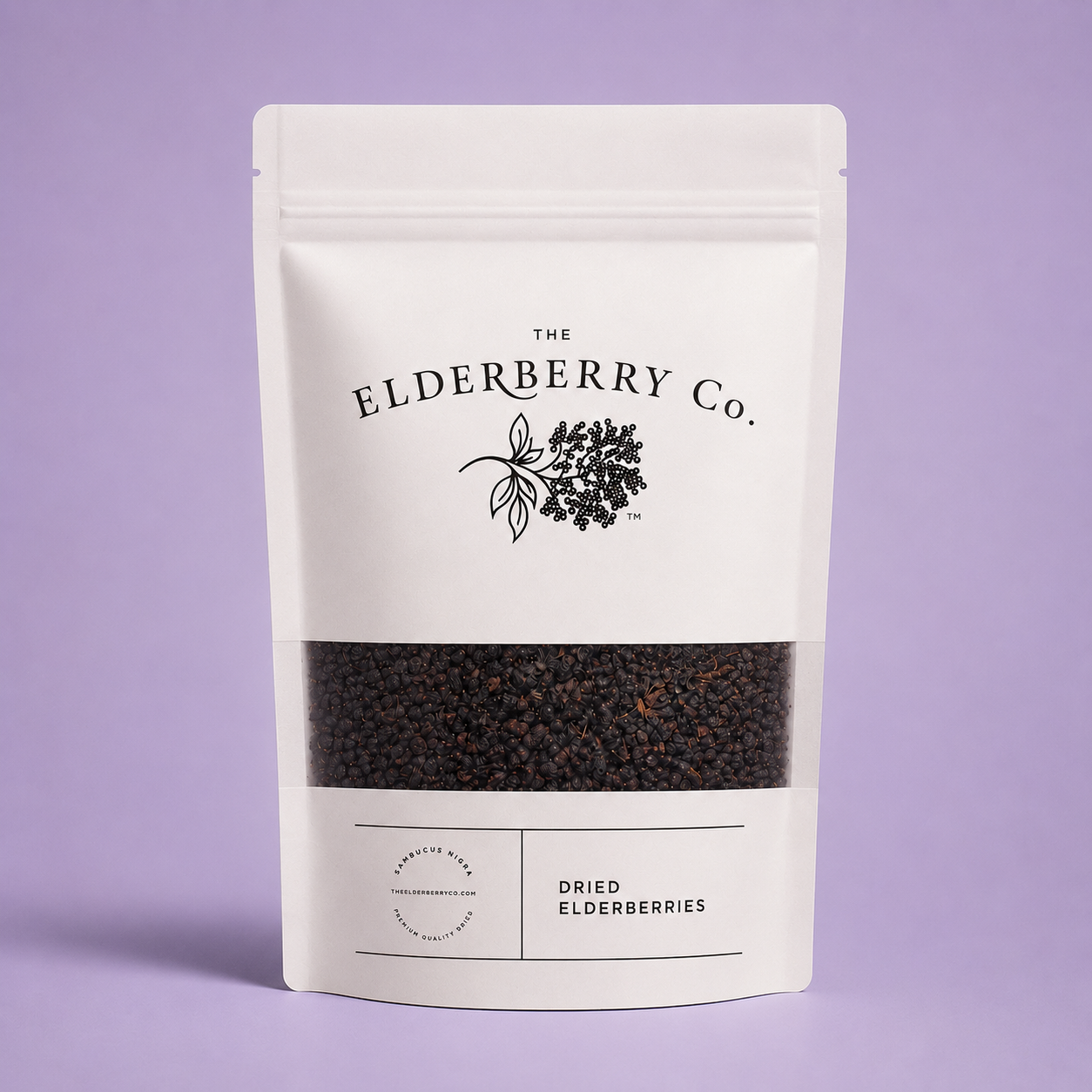 A white stand-up pouch of The Elderberry Co. Dried Elderberries with a clear window showing dark dried berries inside, set against a solid lavender background.