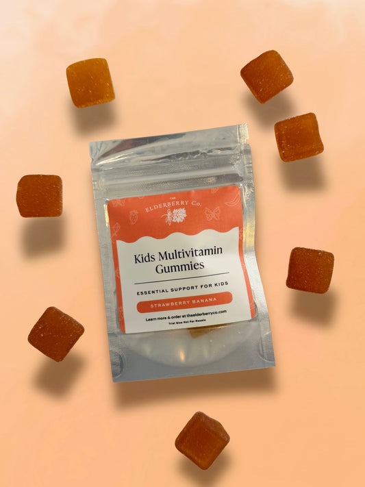 Package of Kids Multivitamin Gummies with scattered gummies on a peach background