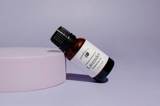 Elderberry Co. Lavender Essential Oil bottle displayed on a pedestal, featuring pure lavender essential oil for aromatherapy, relaxation, and calming home or personal care routines.