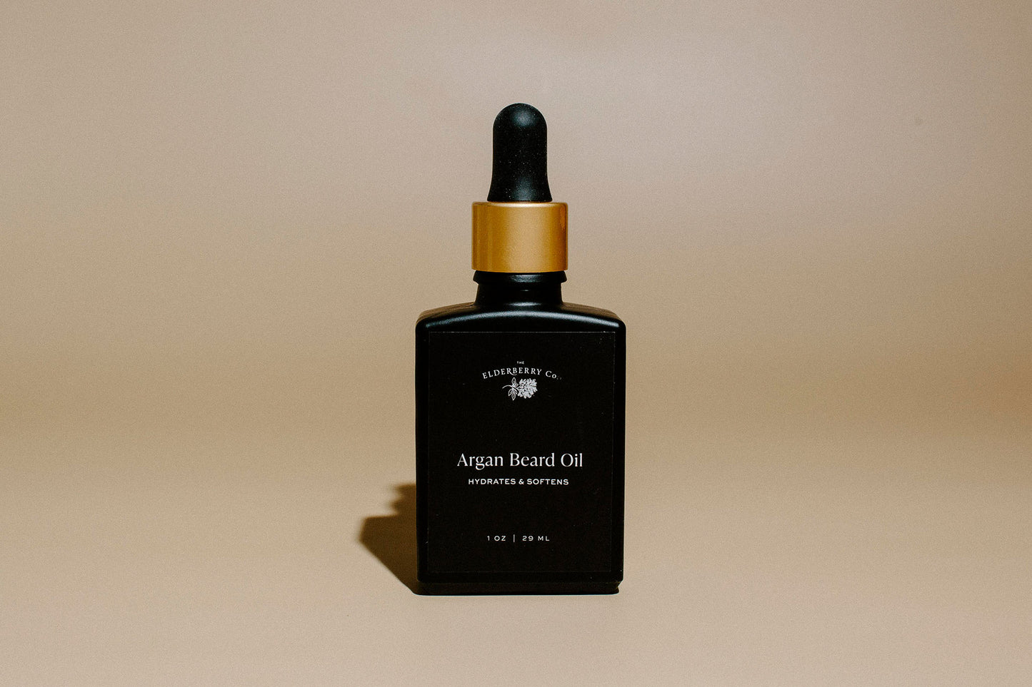 Front view of Elderberry Co. Argan Beard Oil in a black glass dropper bottle with a gold cap, formulated to hydrate, soften, and nourish beards.