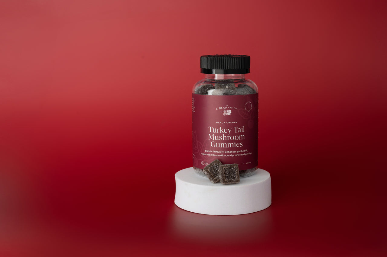 Front of Turkey Tail Mushroom Gummies bottle with black cherry gummies displayed beside it.