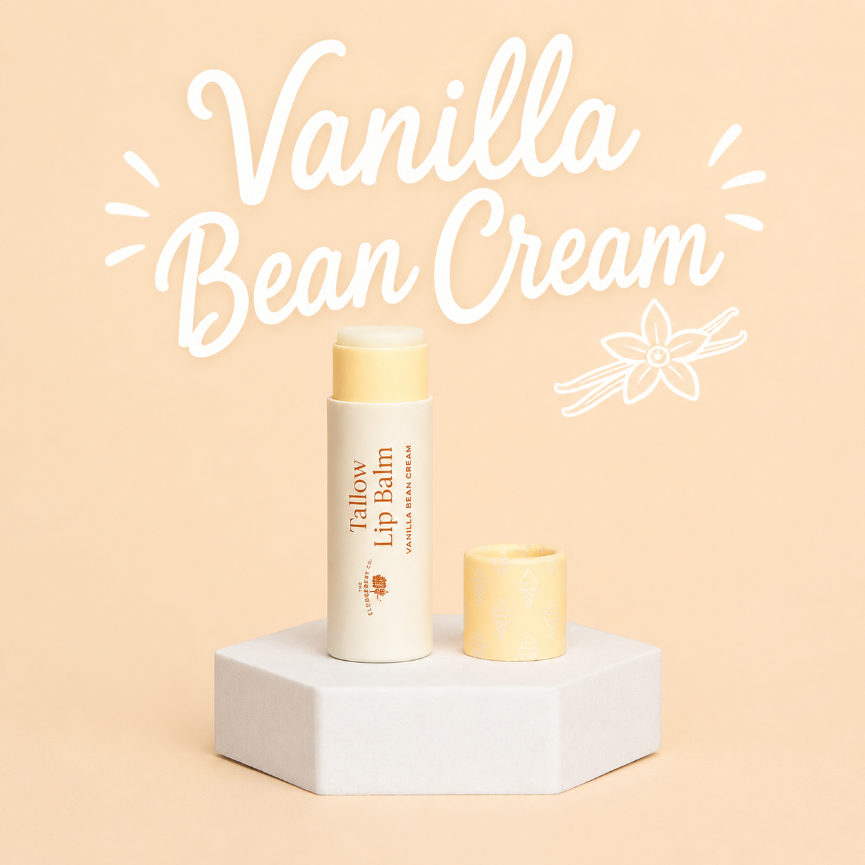 A tube of Fallow Lip Balm in Vanilla Bean Cream stands on a white pedestal against a warm beige background, with the cap placed beside it and large white text reading 'Vanilla Bean Cream' above.