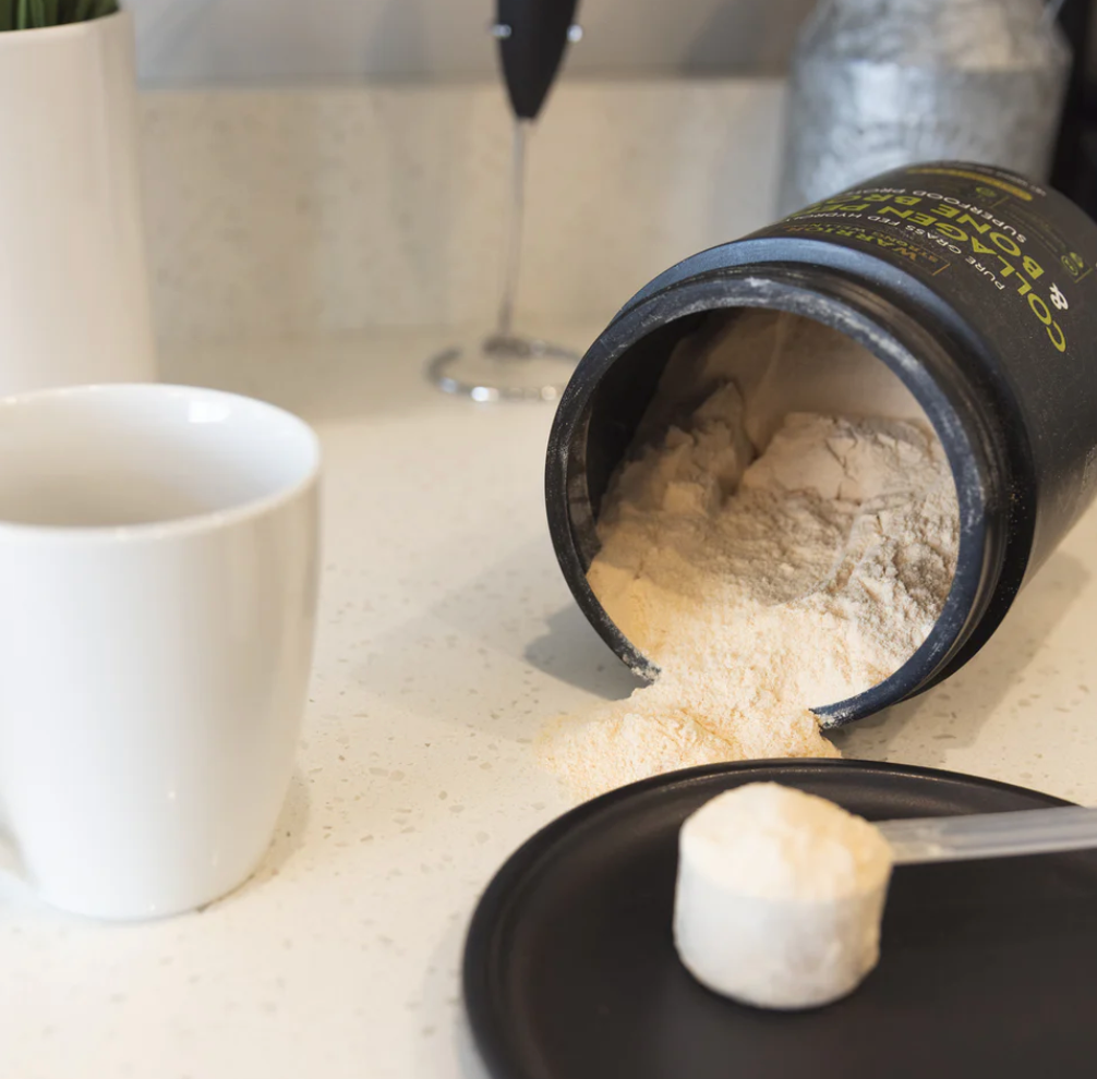 Warrior Strong Wellness Collagen Peptides & Bone Broth Protein with measuring scoop, coffee mug, and frother, demonstrating easy mixing into hot drinks